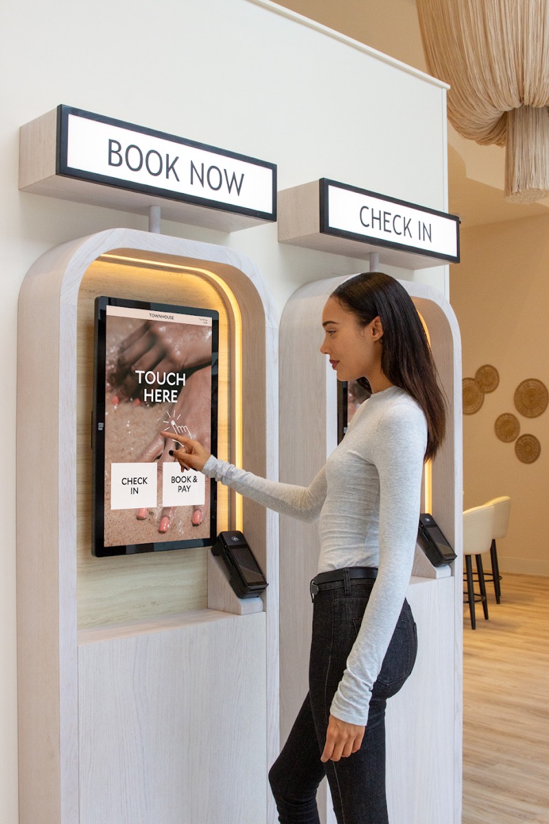 Guest checking in at a Townhouse self-service kiosk